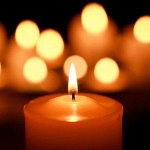 Memorial candles in a dimly lit chapel