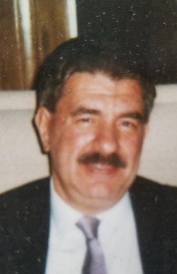 A man in a suit and tie with a mustache.