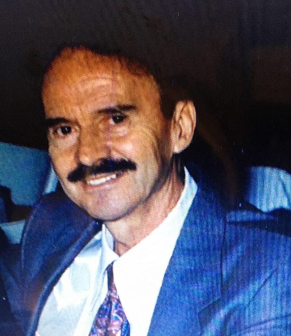 A man in a suit with a mustache.