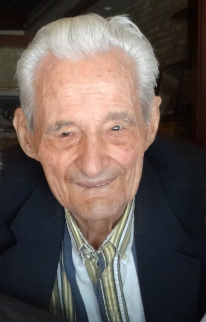 An older man is smiling for the camera.