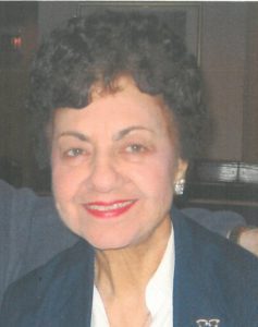 An older woman smiling for the camera.