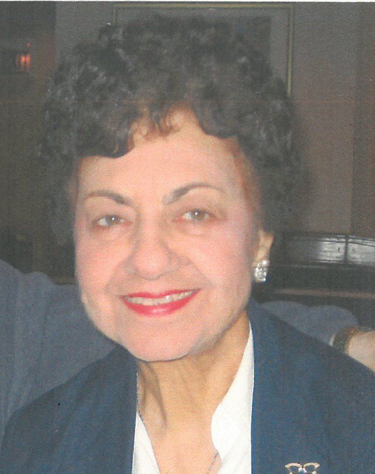 An older woman smiling for the camera.