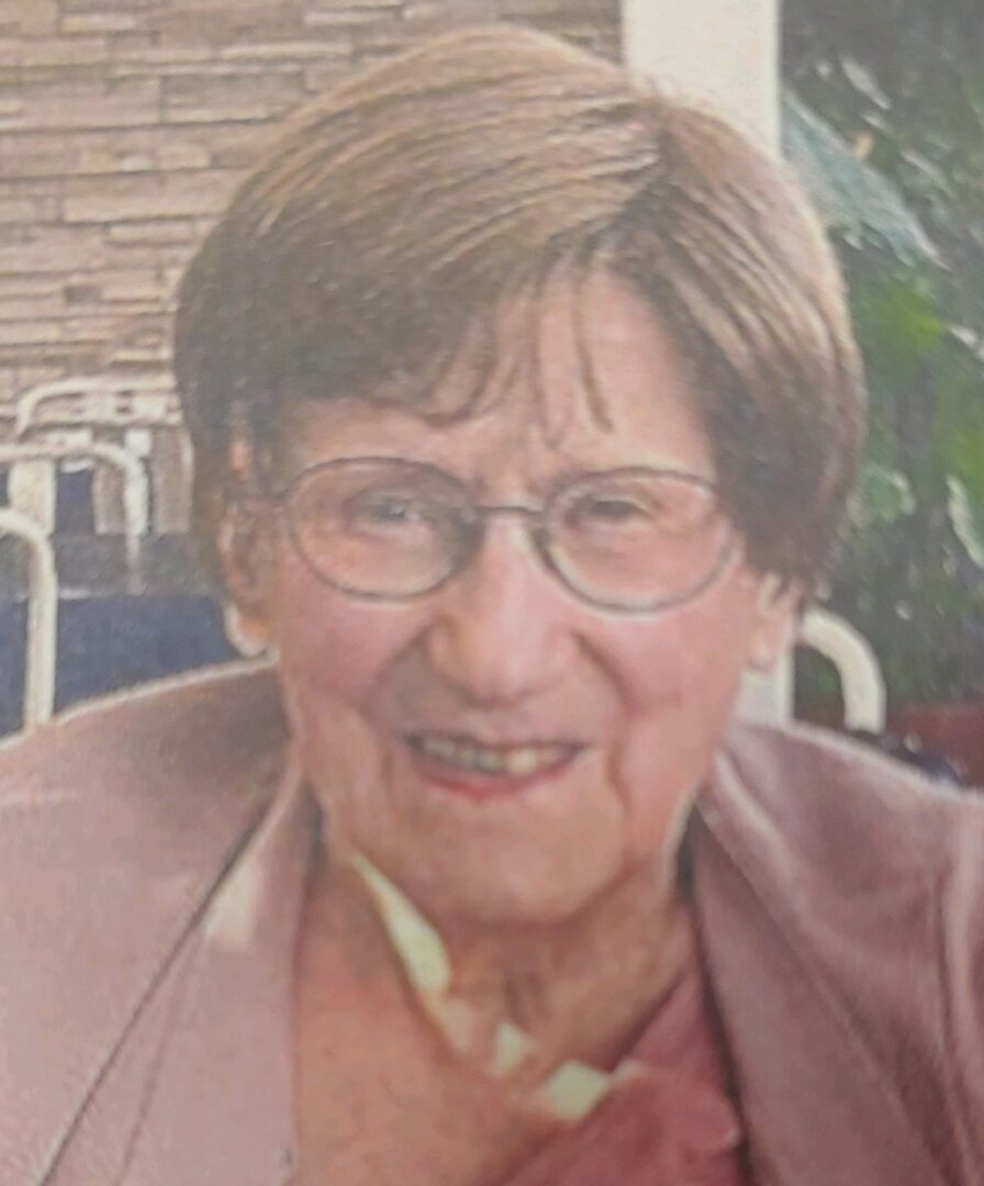 A photo of an older woman wearing glasses.