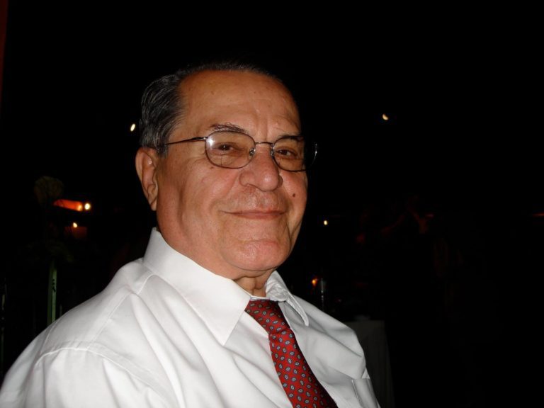 A man in a white shirt and red tie.