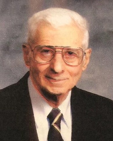 An older man in a suit and tie.