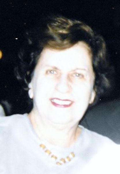 An older woman smiling for the camera.