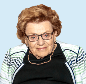 An older woman wearing glasses and a jacket.
