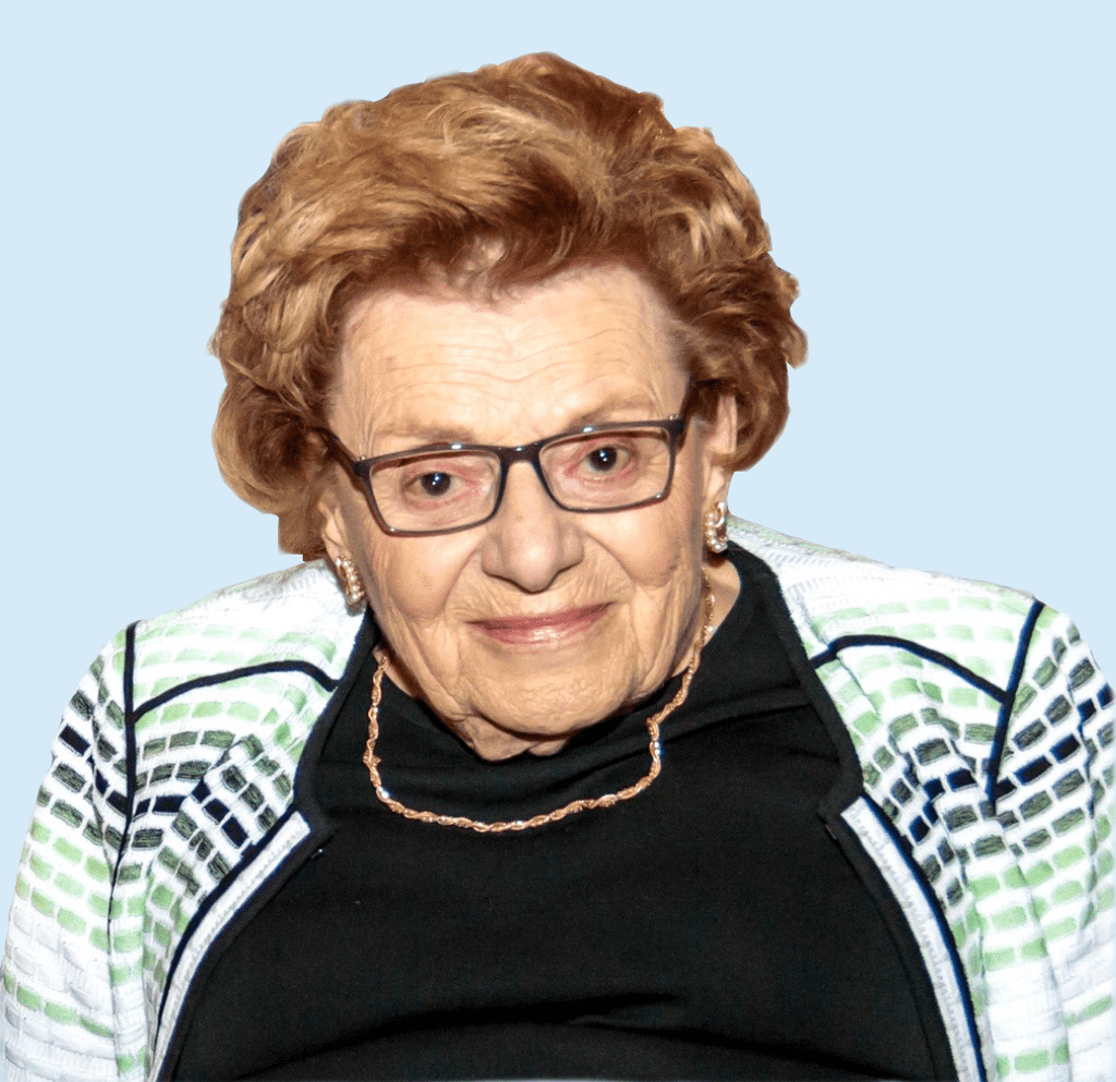 An older woman wearing glasses and a jacket.