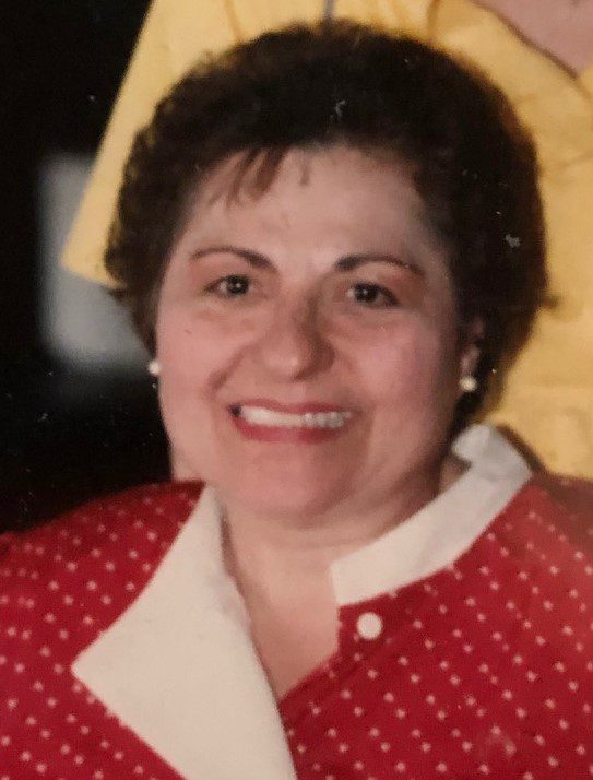 An old photo of a woman in a red polka dot dress.