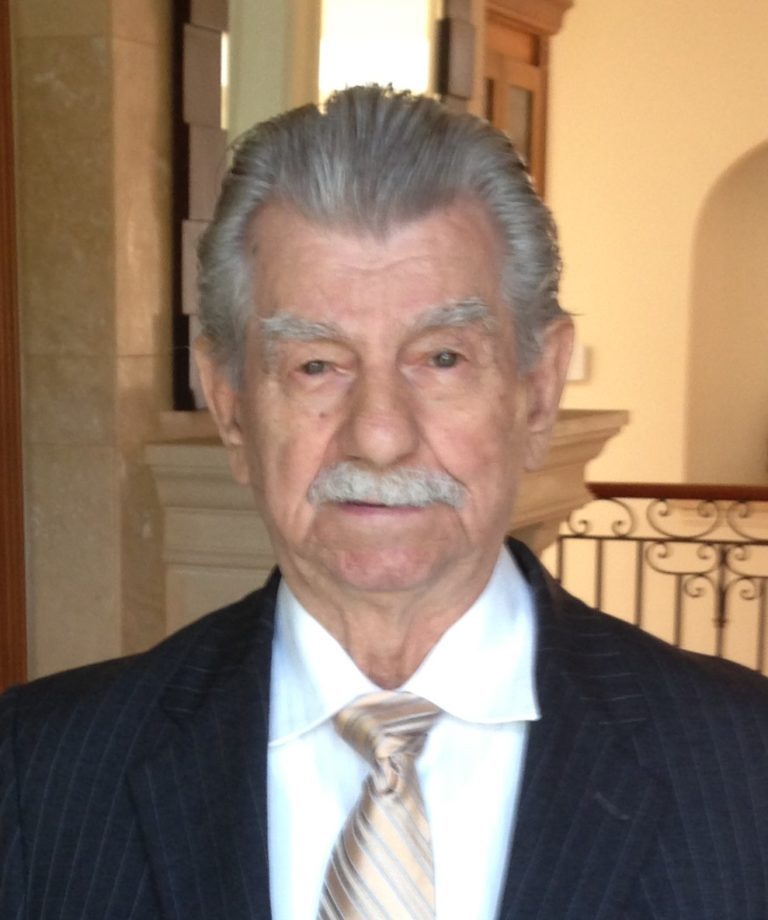 An older man in a suit and tie.