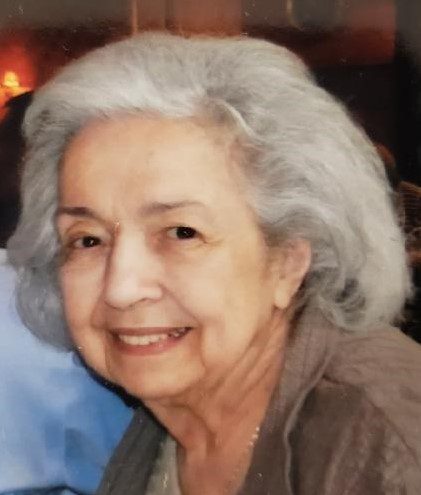 An older woman smiling for the camera.