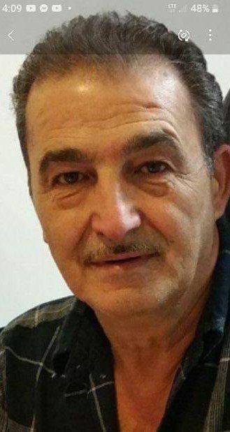 A man with a mustache is posing for a photo.
