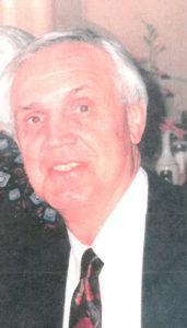 An older man in a suit and tie.