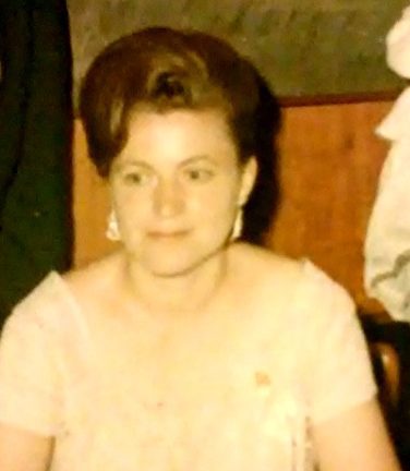 A woman in a dress sitting at a table.