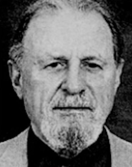 A black and white photo of a man with a beard.