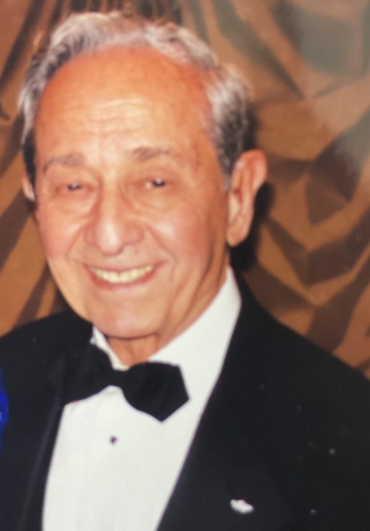 A man in a tuxedo and a woman in a blue dress.