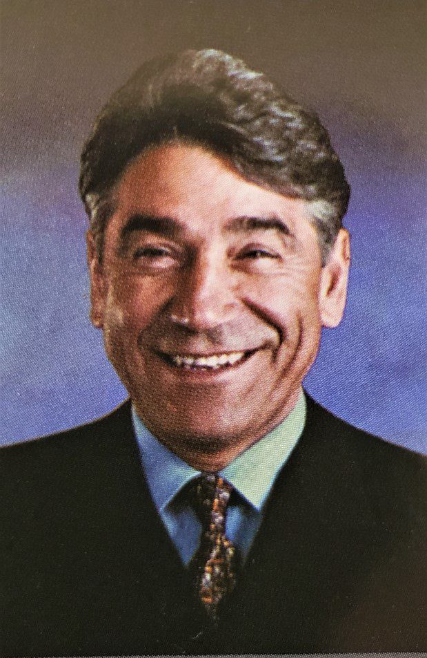 A portrait of a man in a suit and tie.