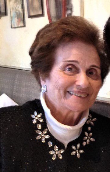 An older woman and a younger woman posing for a photo.
