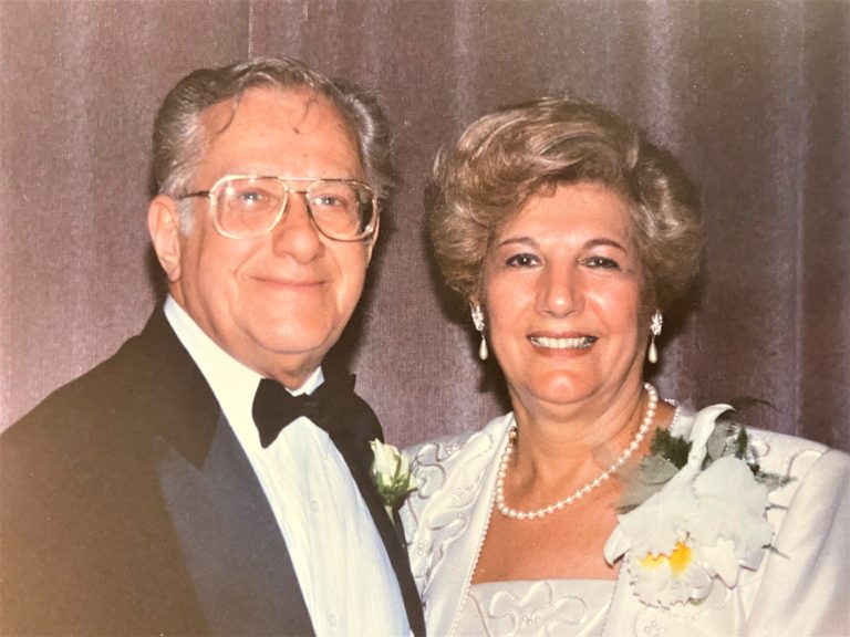 An older man and woman posing for a photo.