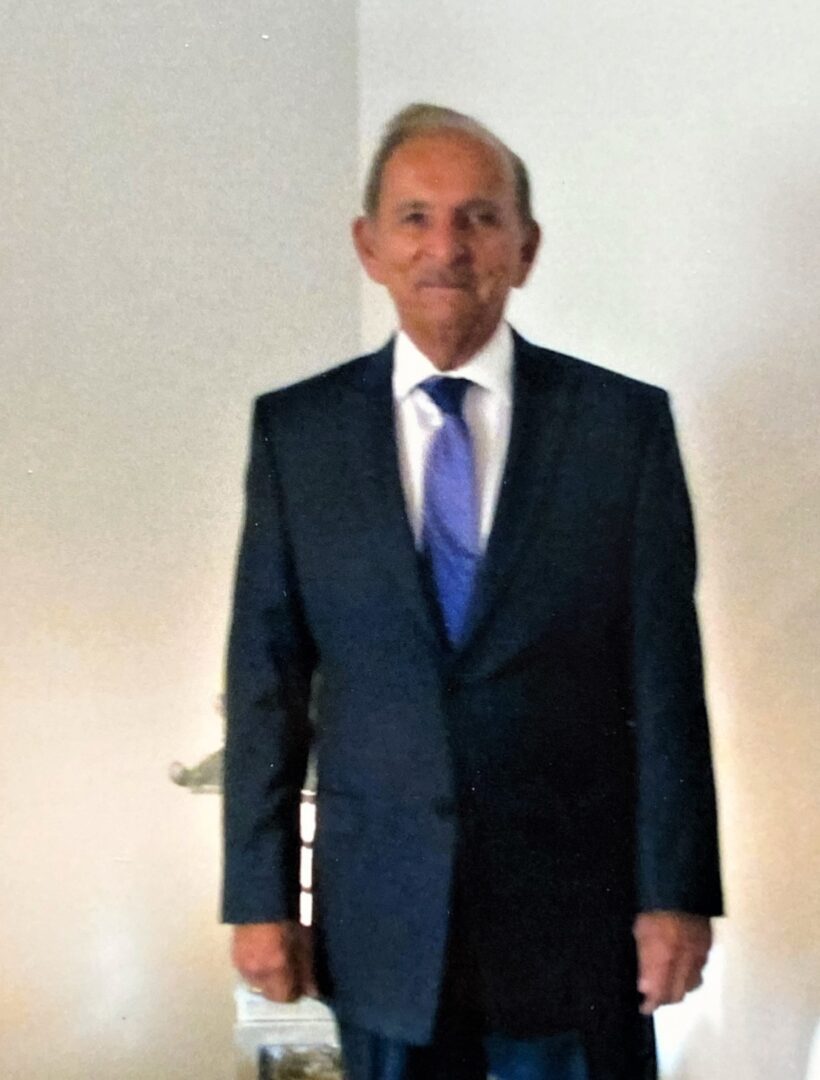 A man in a suit standing in a room.