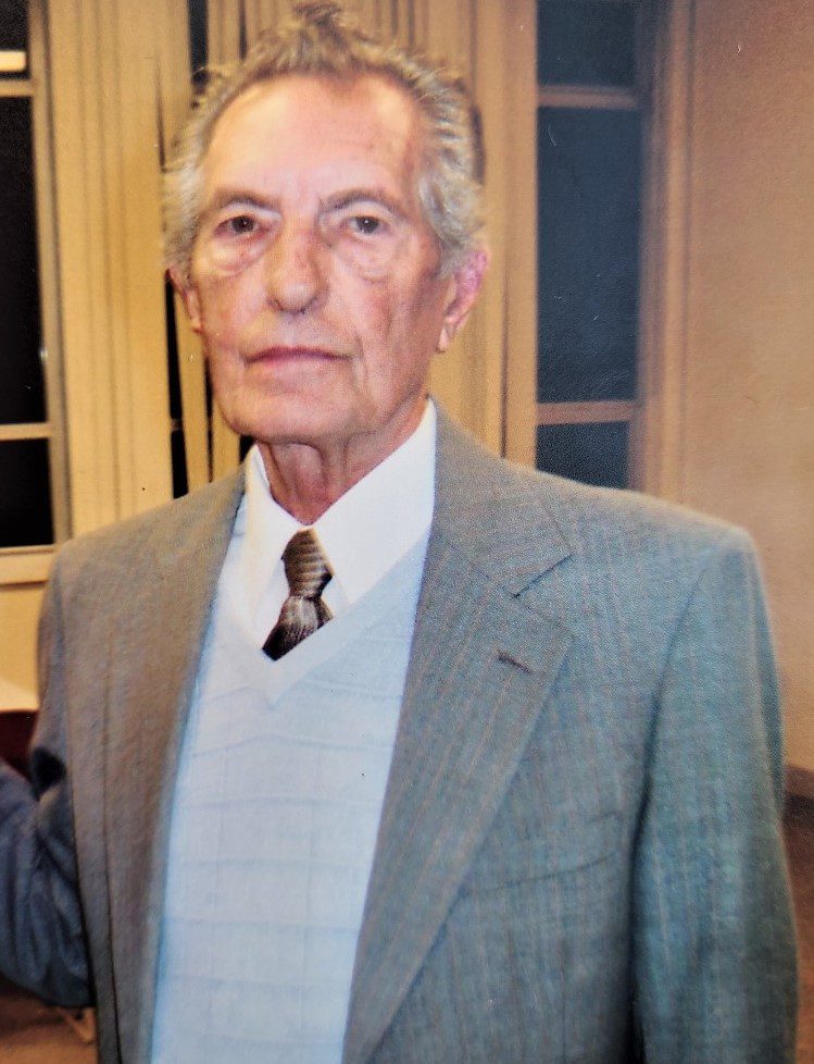 A man in a suit and tie is posing for a photo.