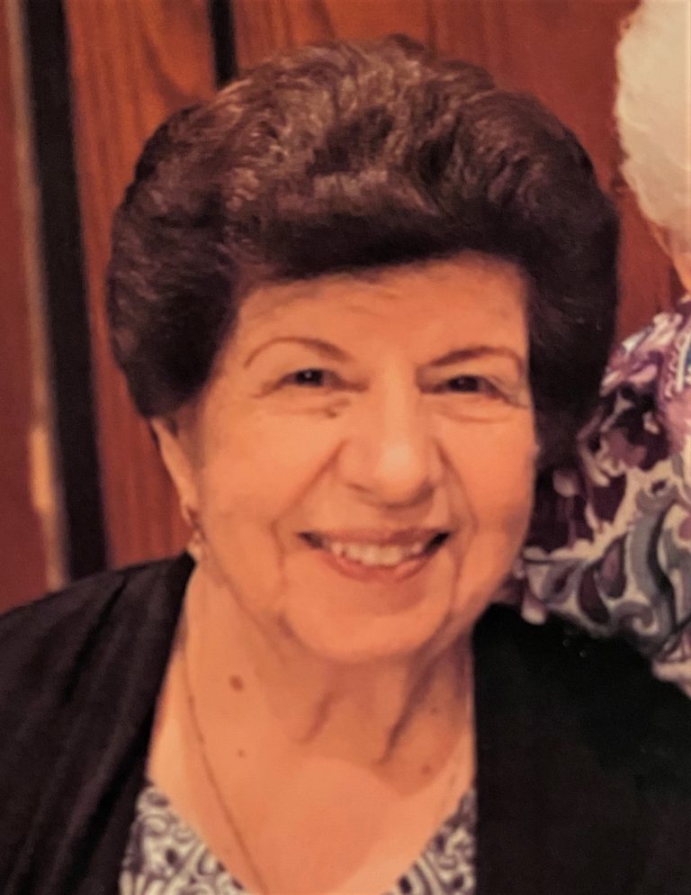An older woman is smiling next to an older woman.
