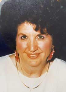 An old photo of a woman with curly hair.