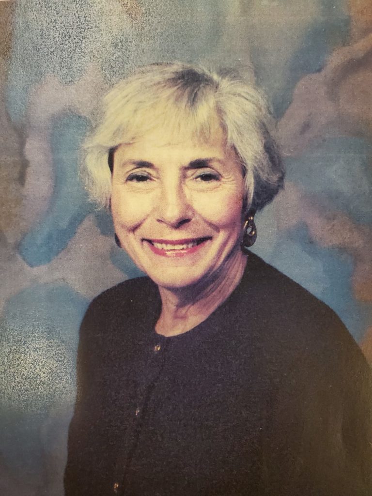 An older woman smiling for the camera.