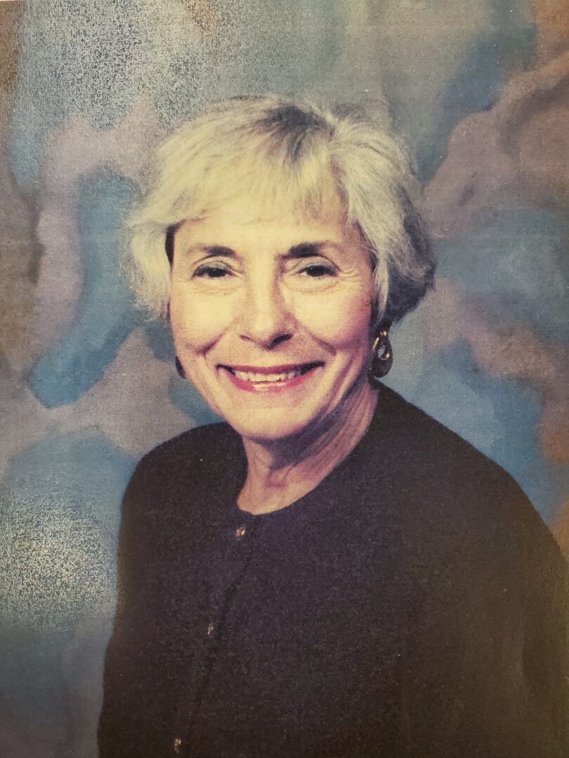An older woman smiling for the camera.