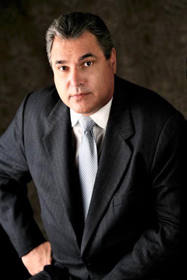 A man in a suit posing for a photo.