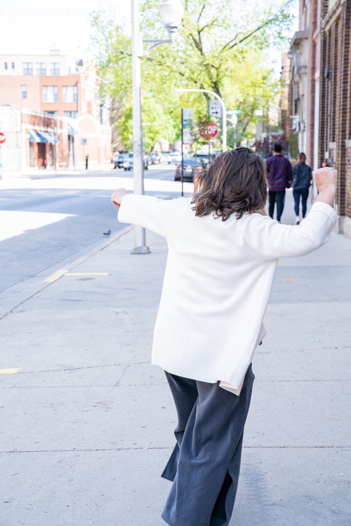 A woman riding a skateboard on a city street.