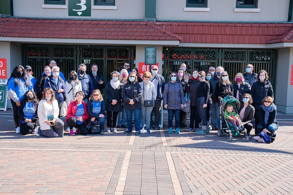 A group of people posing in front of a building.