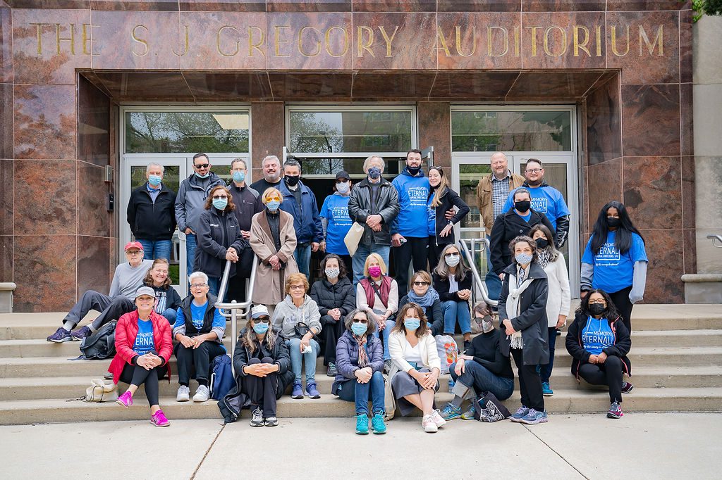 A group of people posing in front of a building.