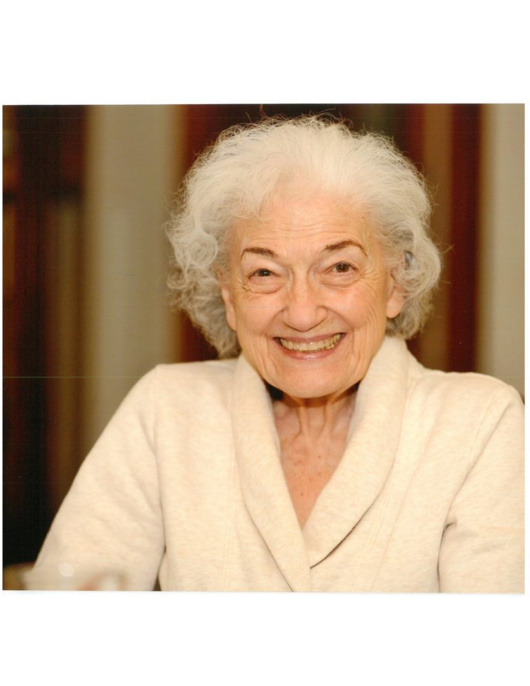 An older woman smiling for the camera.