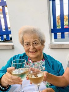 An older woman and a young girl holding wine glasses.
