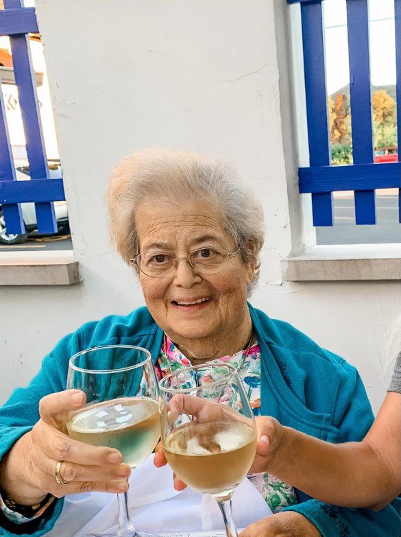 An older woman and a young girl holding wine glasses.