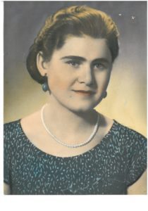 An old photo of a woman with pearls.