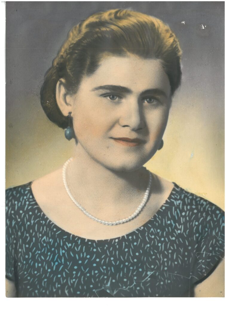 An old photo of a woman with pearls.