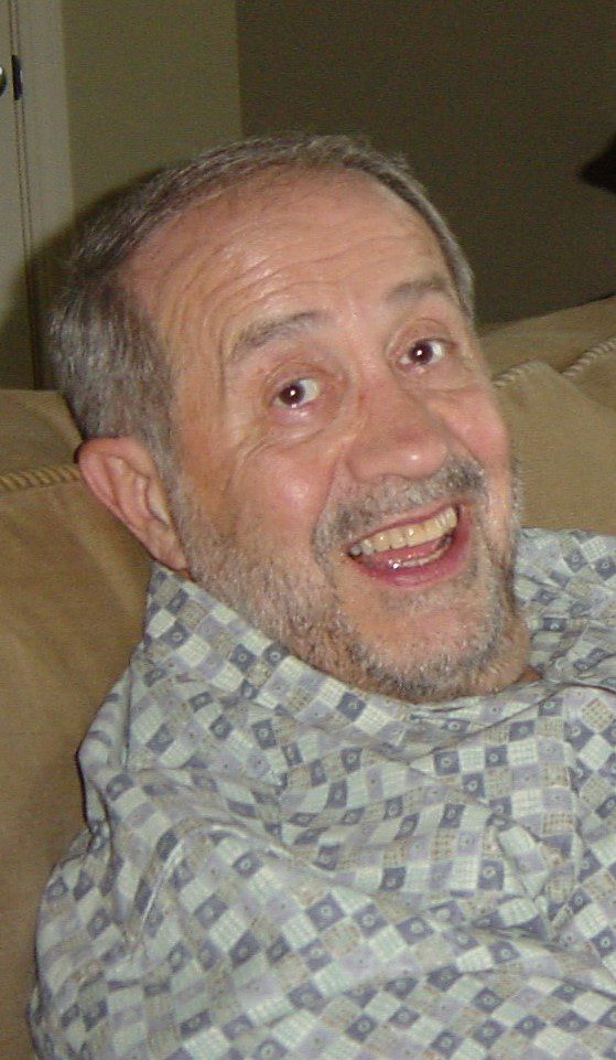 A man is sitting on a couch.