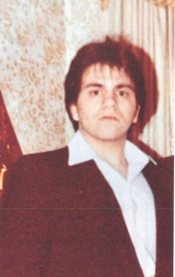 A man in a suit posing for a photo.