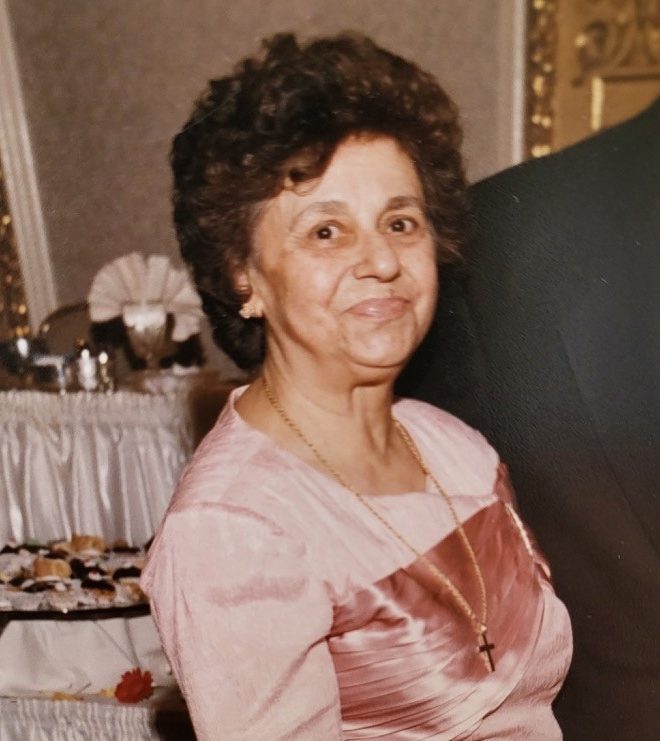 A woman in a pink dress standing next to a man.