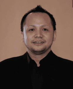 A man wearing a black shirt and black jacket.