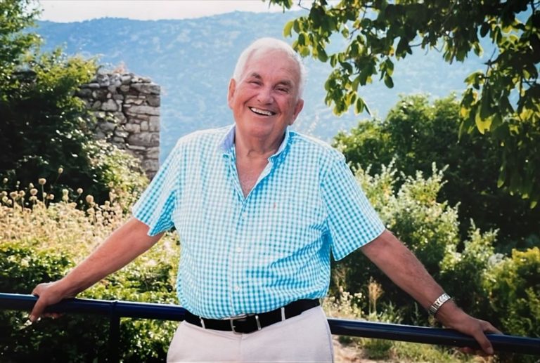 Close up image of an old man smiling at the camera