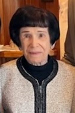 An older woman is posing for a picture.