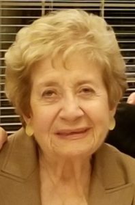 An older woman is posing for a photo.