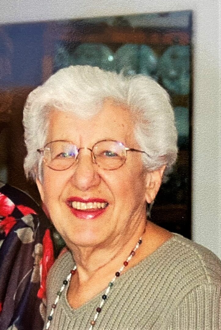 Two older women smiling for the camera.