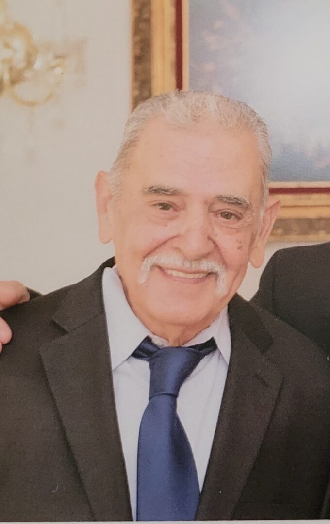 Two older men posing for a photo.