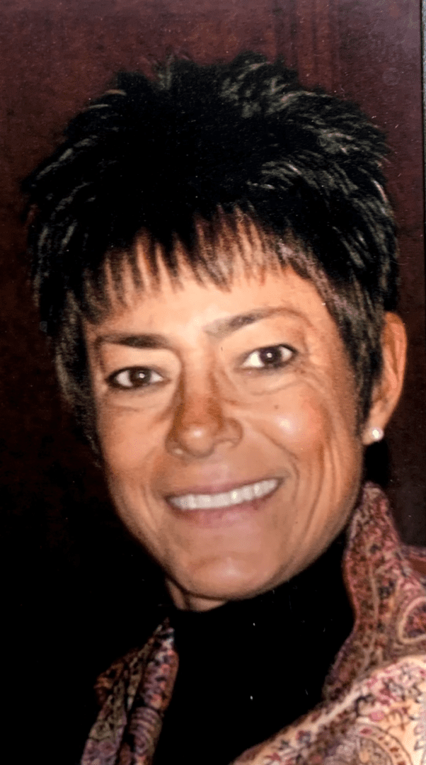 A woman with short hair smiling for the camera.