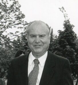 A black and white photo of a man in a suit.