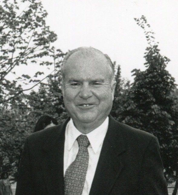 A black and white photo of a man in a suit.